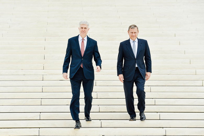 A wide shot of the Supreme Court steps as Gorsuch and Roberts walk down them